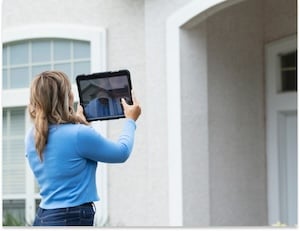  Female real estate agent taking photos of a property