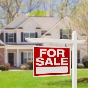  For sale sign in front of a home.